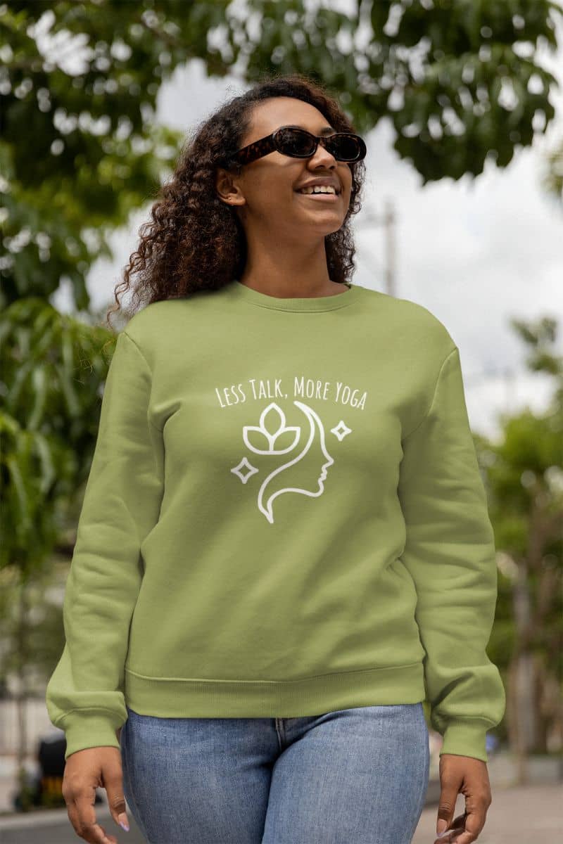 Less talk, more yoga sweatshirt with a girl with curly hair and glasses walking down the street