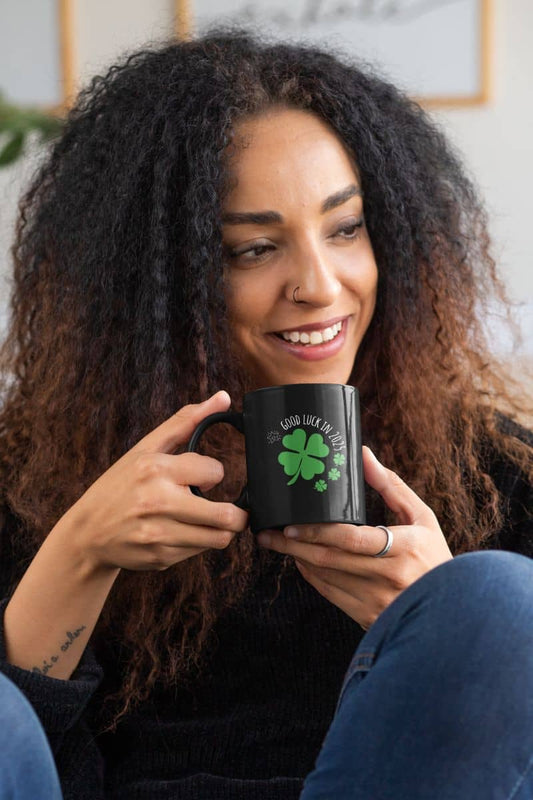 Lucky Charm 11 oz Mug with the girl smiling brightly while holding a cup of coffee in both hands
