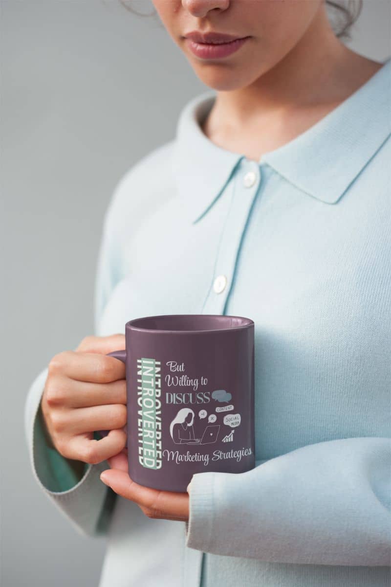 Marketing fuel mug with a girl looking at the cup in front of her chest