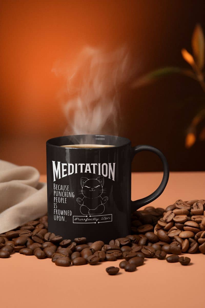 Meditation mug with a hot cup of coffee next to the coffee beans
