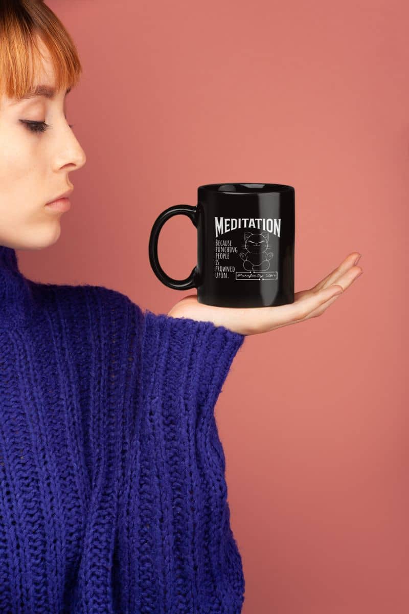 Meditation mug with a girl holding a cup in her palm and looking at it