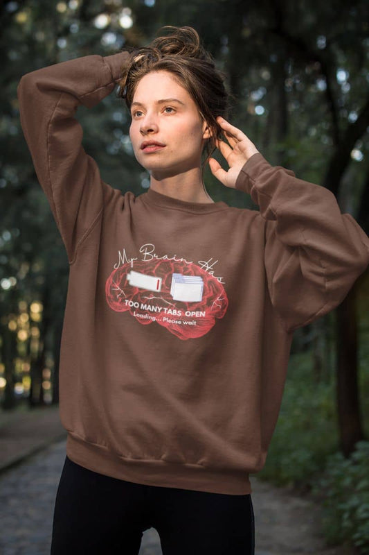 Mental overload sweatshirt with a girl posing in the forest with her hair pulled back