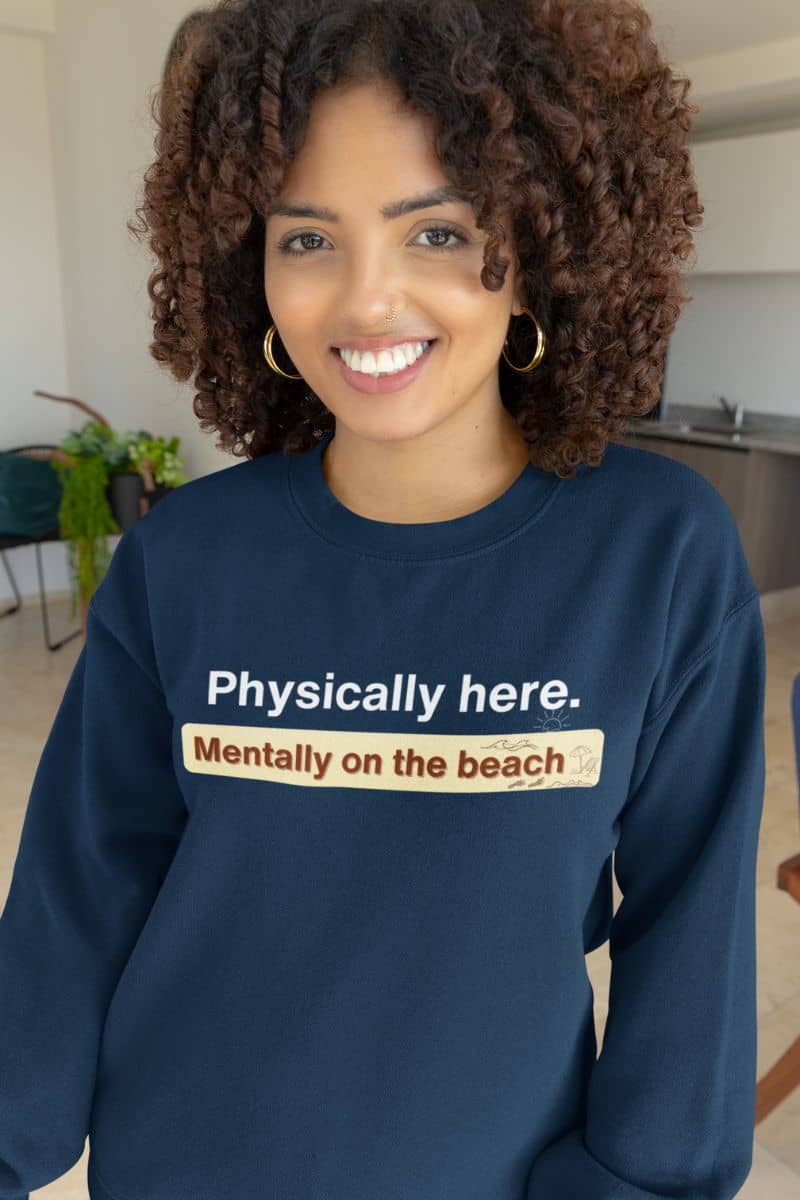 Mentally on the beach sweatshirt with a person wearing a navy sweatshirt with humorous text in a casual indoor setting