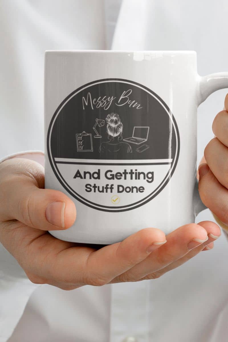 Messy bun coffee mug with a man in a white shirt holding a cup of coffee in front of his chest