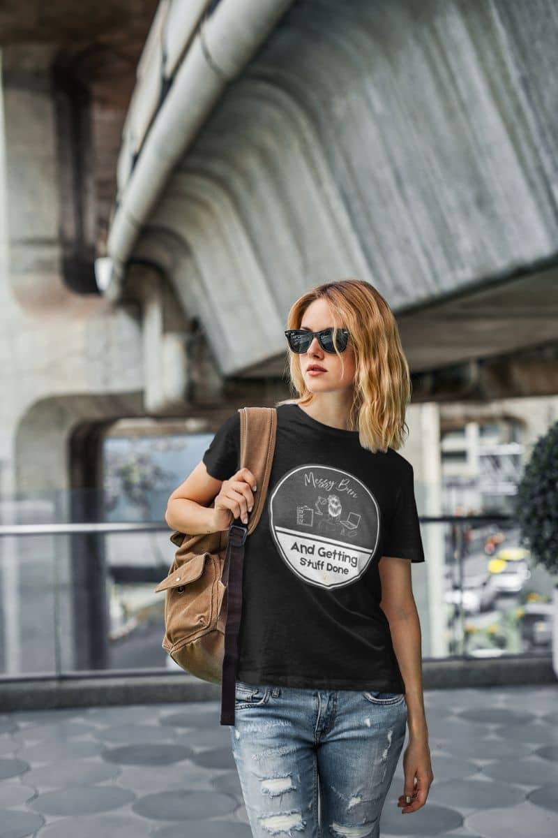 Messy bun t-shirt with the girl wearing a backpack and glasses standing under the bridge