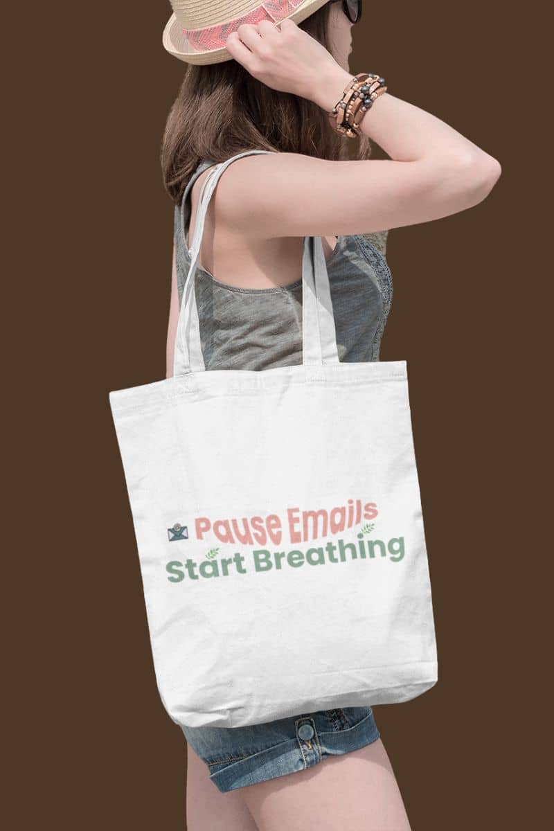 Mindful lifestyle tote with a person holding a tote bag with text 'Pause Emails Start Breathing' on a brown background