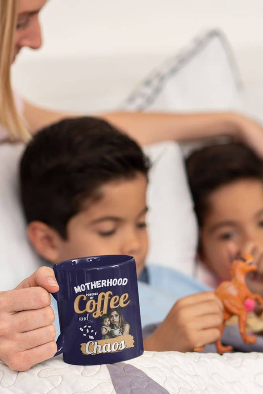 Mom fuel mug with a mother lying and talking to her two sons on the bed while still holding a cup of coffee