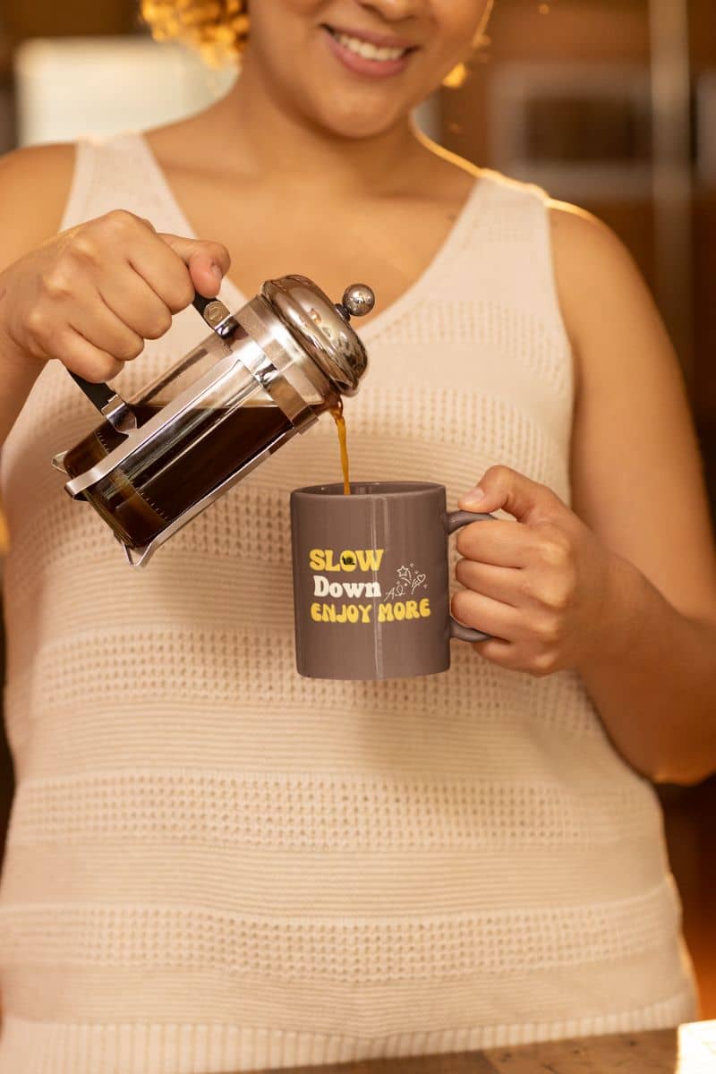 Motivational coffee mug with a woman pouring coffee into a cup