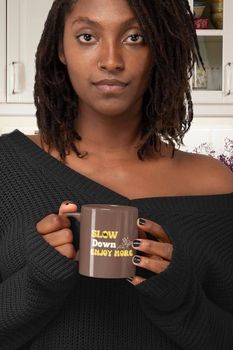 Motivational coffee mug with a girl wearing an off-shoulder sweater holding a cup in the kitchen