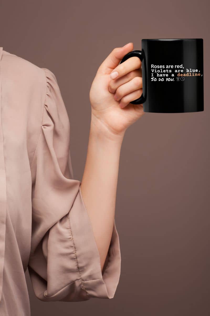 Motivational deadline mug with the girl holding the cup with one hand