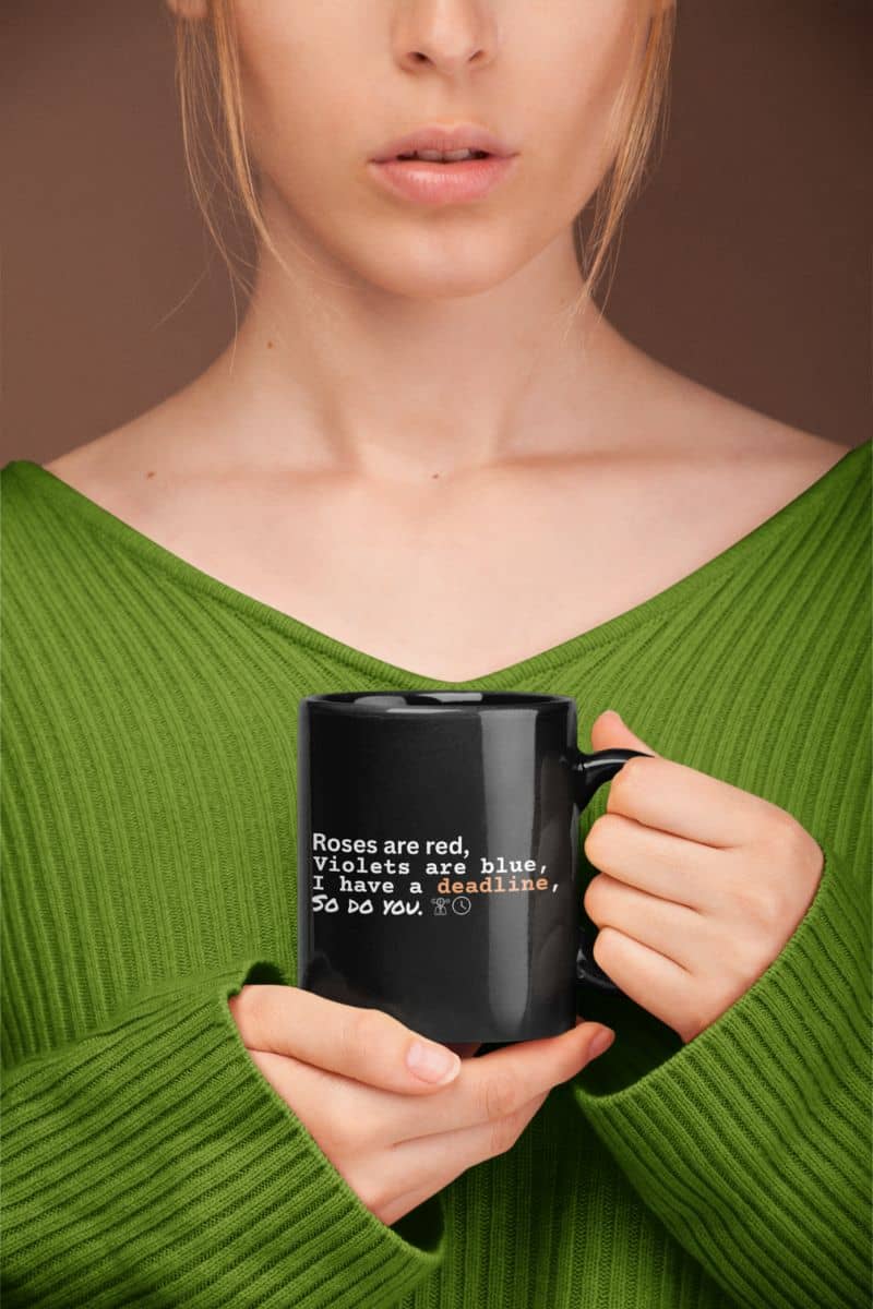 Motivational deadline mug with the girl holding the cup in front of her chest