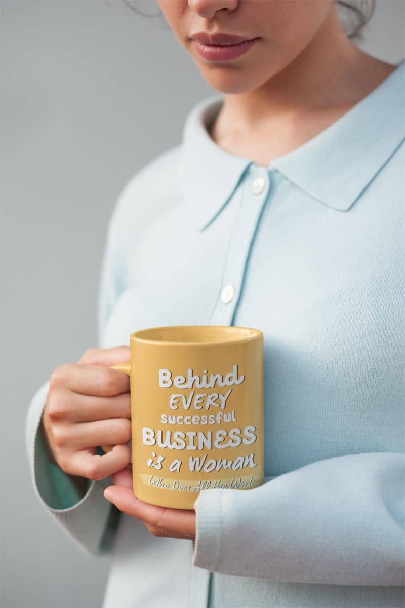 Motivational mugs with a girl holding a cup in front of her chest