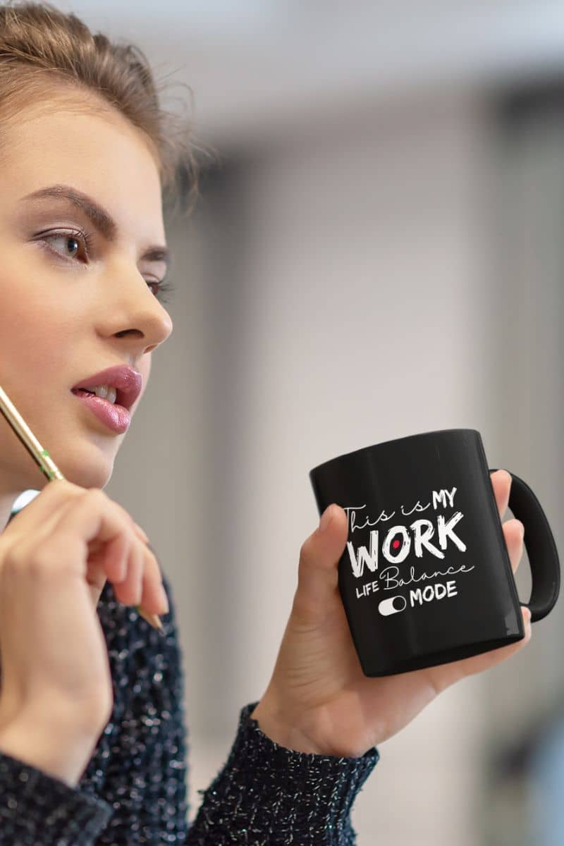 Motivational work life balance mug with a girl thinking with a cup of coffee and a pencil in her hand
