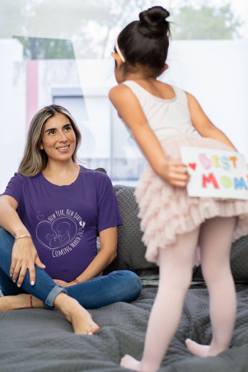 New Year, New Baby Coming March 2025 T-Shirt a pregnant woman talking to her daughter