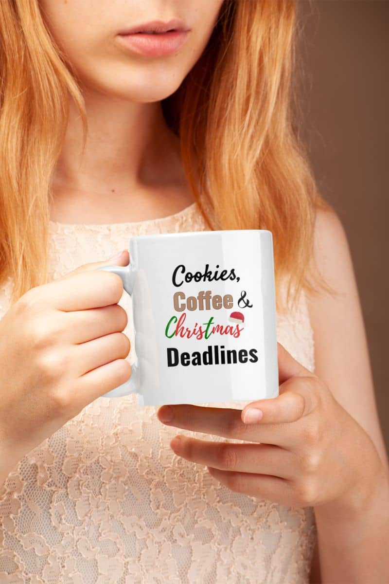 Office christmas coffee mug with a person holding a mug with 'Cookies, Coffee & Christmas Deadlines' text