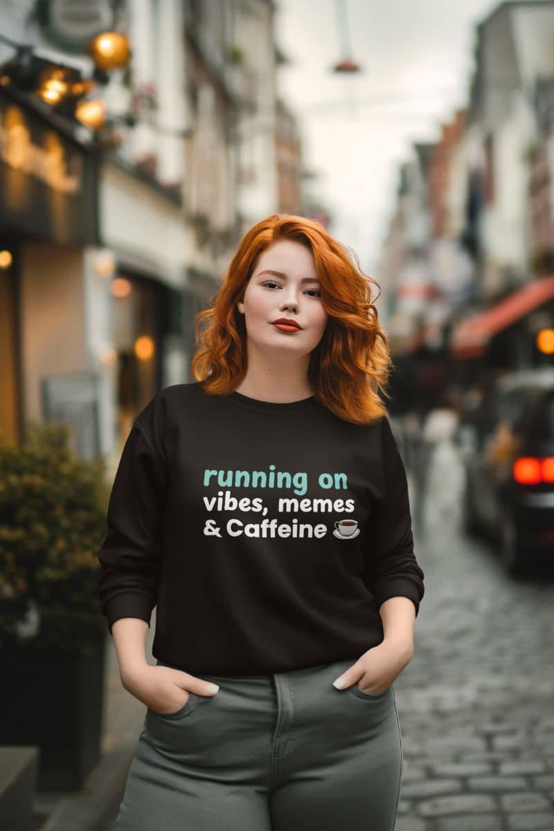 Oversized meme sweatshirt with a woman wearing a black sweatshirt with text 'Running on Vibes, Memes & Caffeine' on a city street