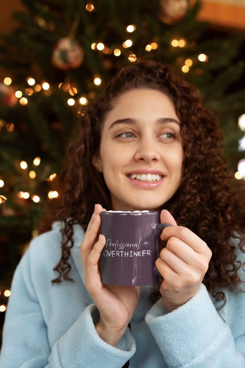 Overthinker mug with a girl holding a cup of coffee with a bright smile on Christmas night