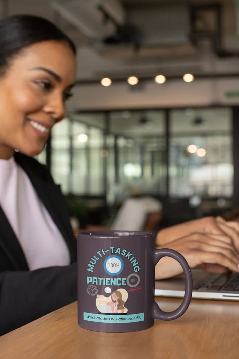 Patience OFF coffee mug with a girl working on a laptop next to a cup of coffee on the table