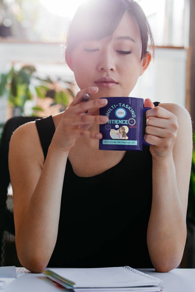 Patience OFF coffee mug with a girl working while holding a cup and a pen