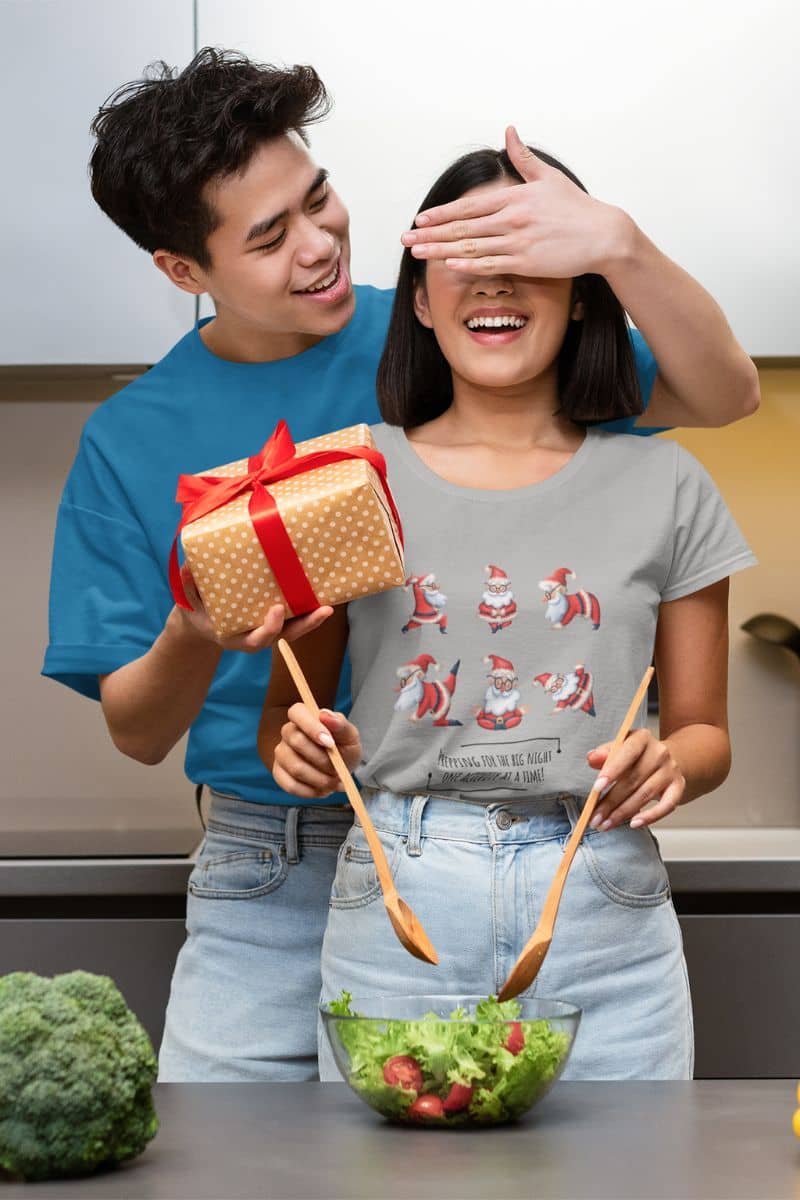 Prepping For The Big Night One Activity At A Time T-Shirt with A guy is giving a gift to his girlfriend in the kitchen.