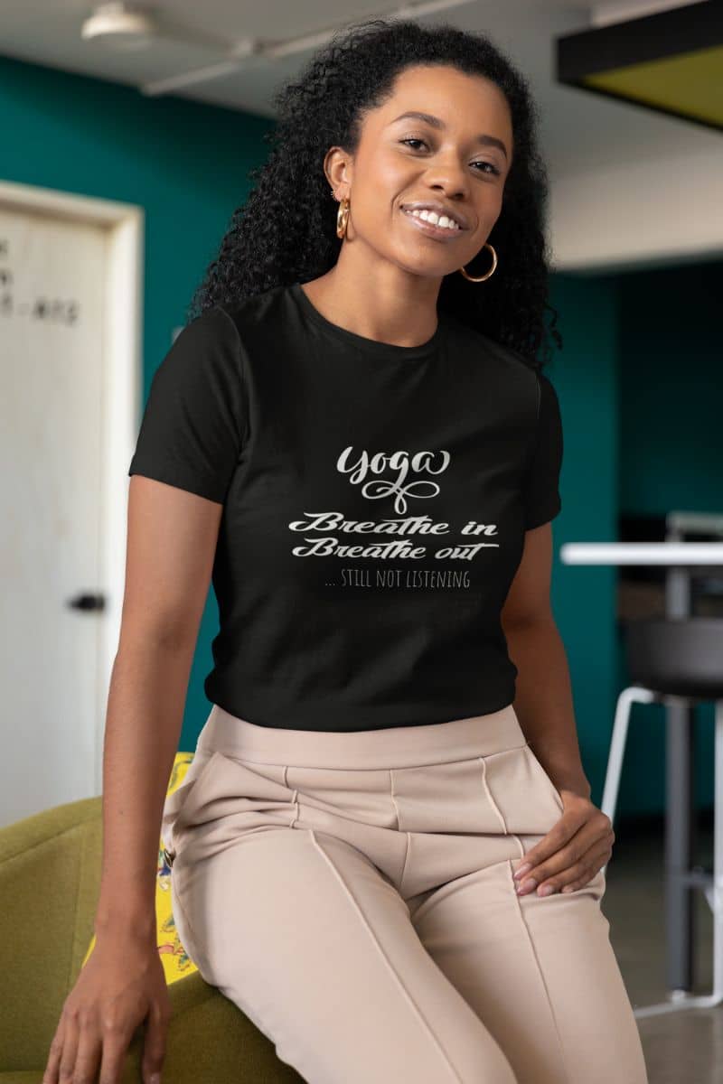 Quirky yoga T-shirt with the girl leaning back in her chair and posing with a smile