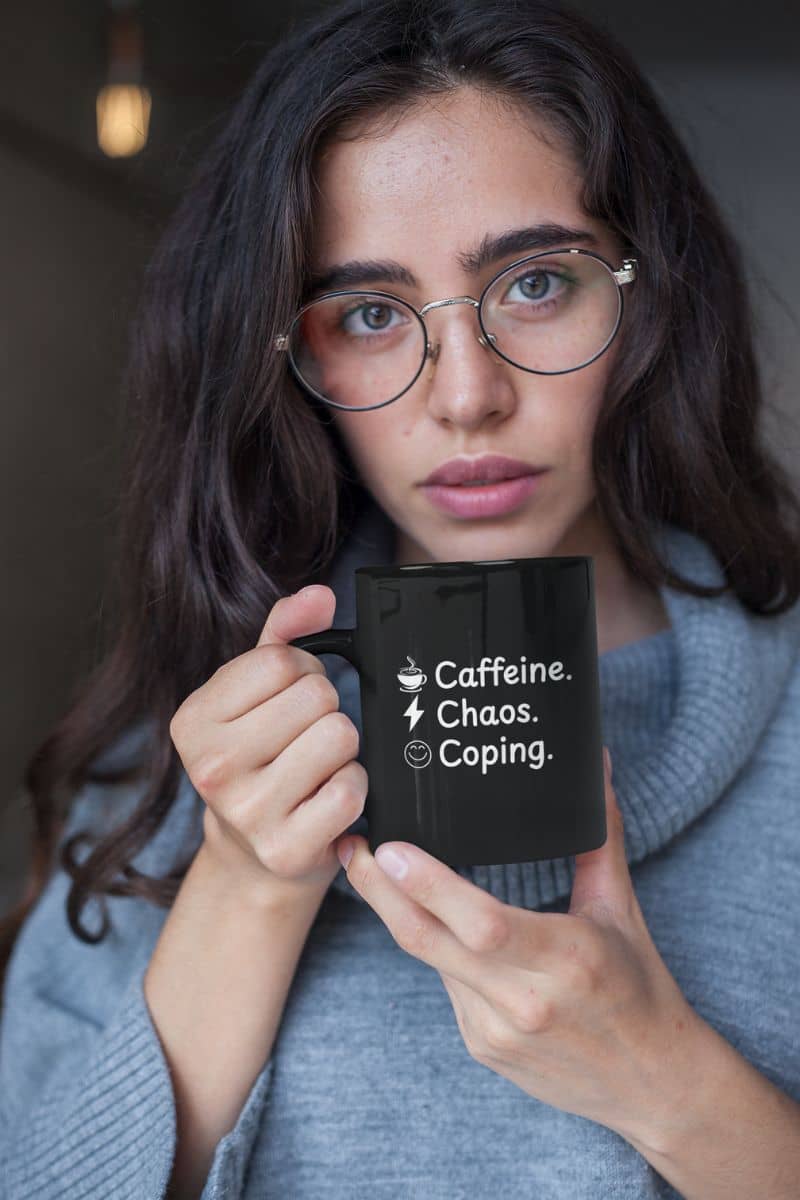 Remote work survival mug with a woman holding a mug with text 'Caffeine. Chaos. Coping.'