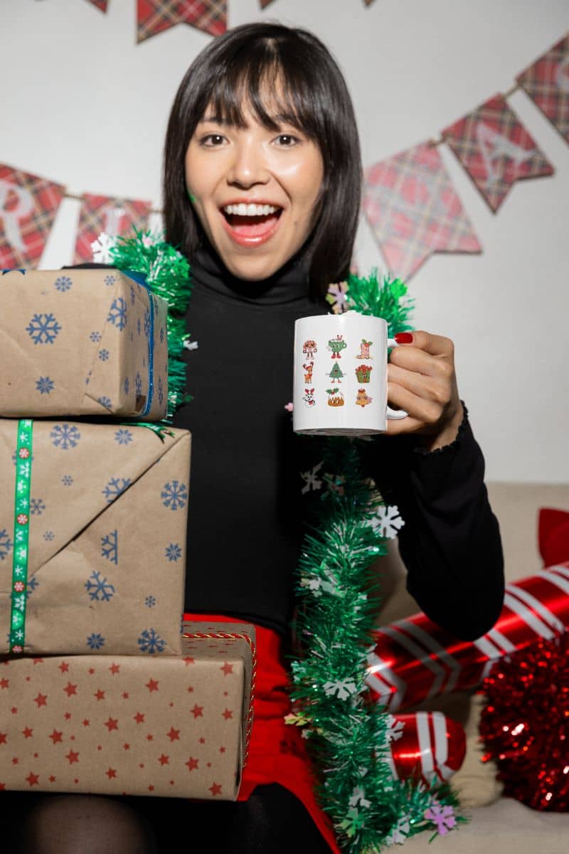 Retro Christmas Vibes Mug with a girl holding a cup next to her gifts