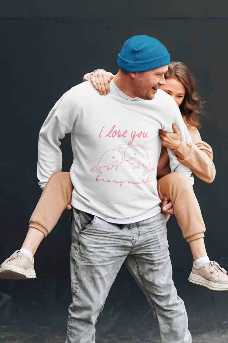 Romantic Dolphin love sweatshirt with a man carrying his girlfriend on his back and smiling brightly together