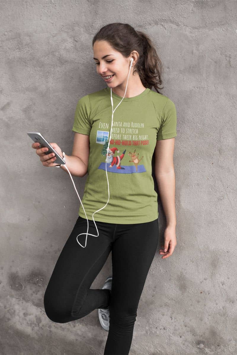 Santa and Rudolph Stretch Before the Big Night T-Shirt with a young girl is exercising, wearing headphones and leaning against the wall to listen to music.