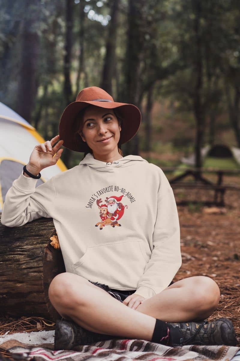 Cozy Christmas Hoodie with a girl posing near her tent