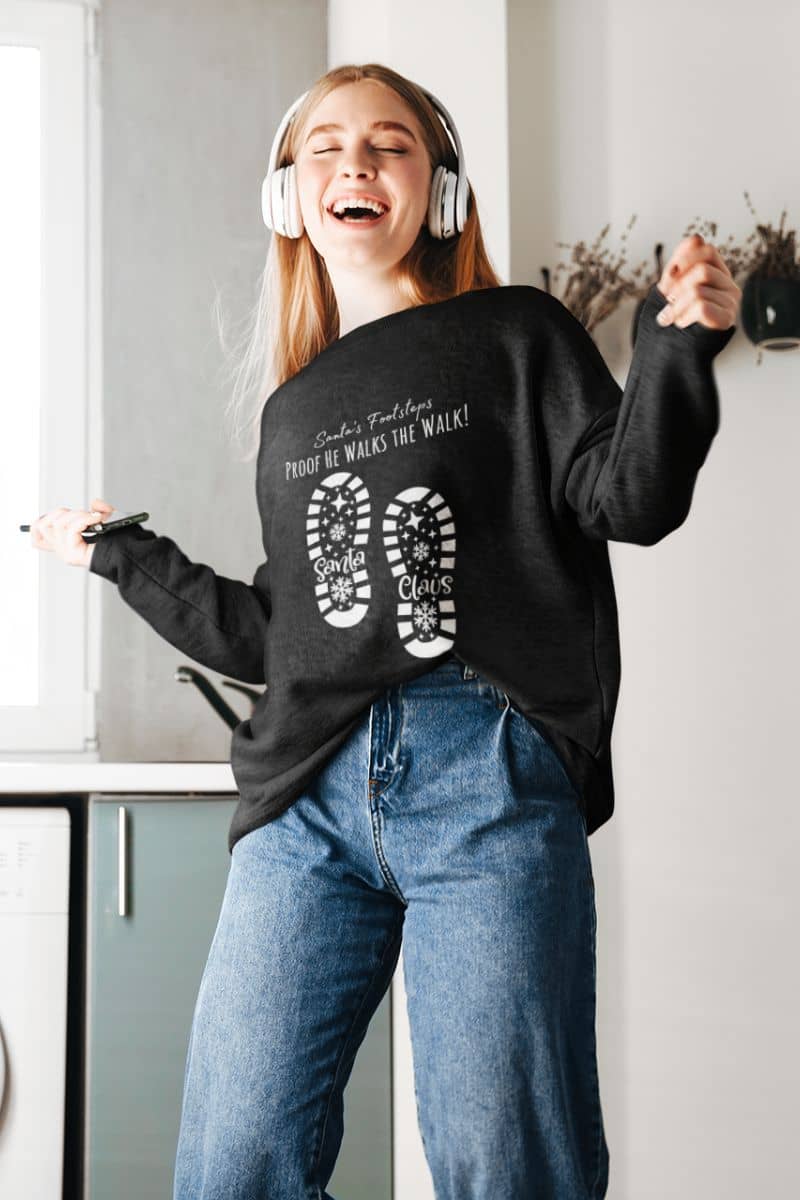Santa's Footsteps Sweatshirt with the girl wearing headphones and grooving to the music