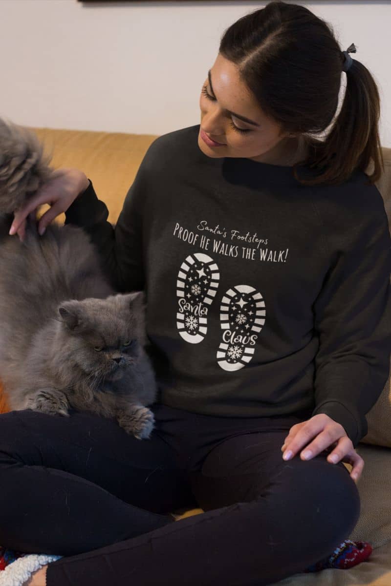 Santa's Footsteps Sweatshirt with the girl playing with her black cat