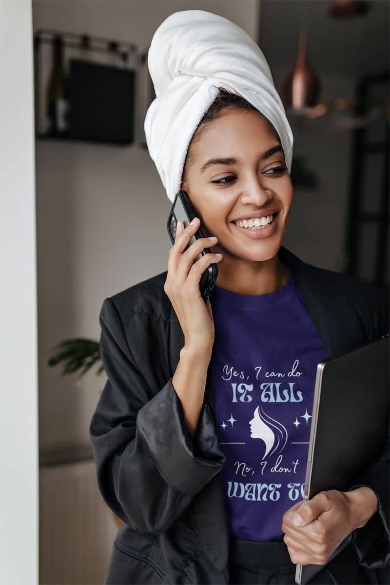 Sarcastic graphic t-shirt with a girl happily talking on the phone while holding a laptop in one hand and wearing a headscarf with a business suit