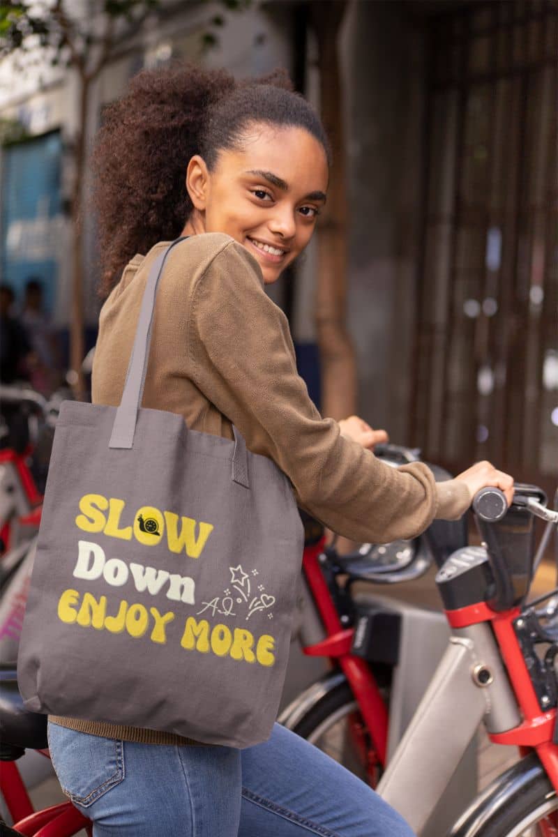 Slow living tote bag with a girl riding a bike to school