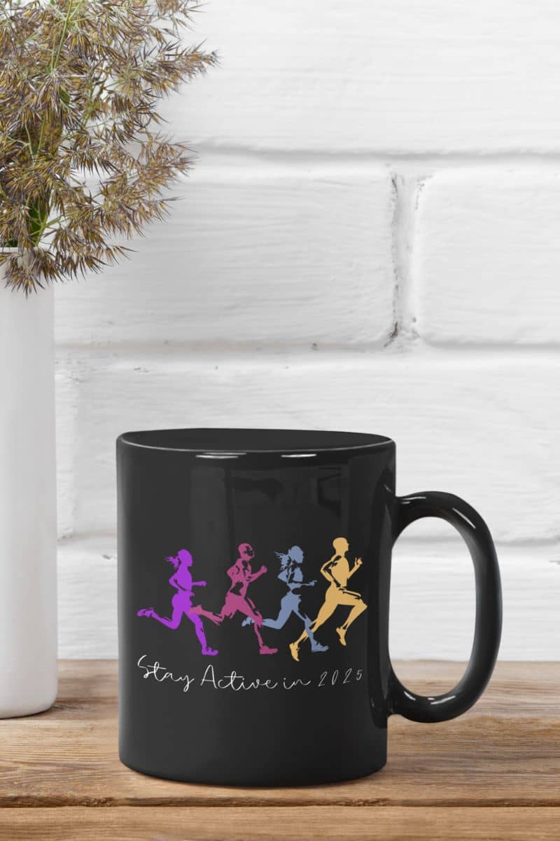 Stay active in 2025 coffee mug with a cup of coffee on the table next to a vase of flowers