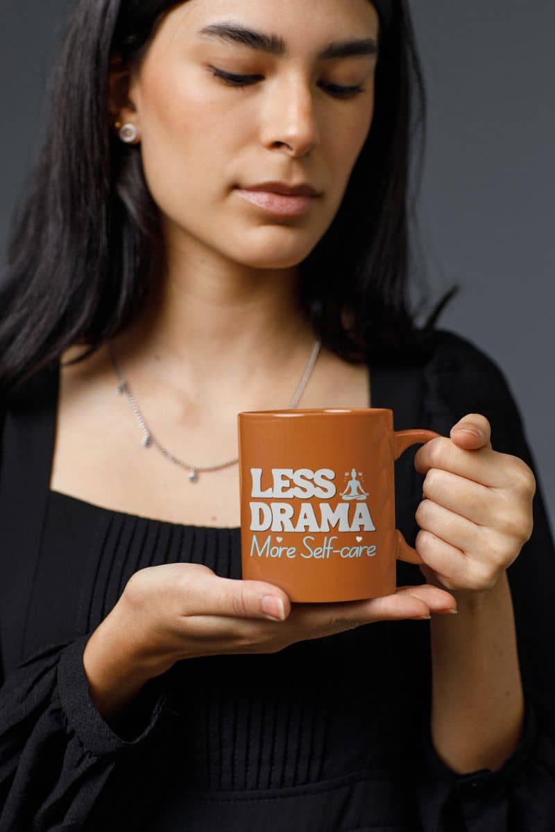 Unique ceramic mug with a girl looking at the cup in her hand