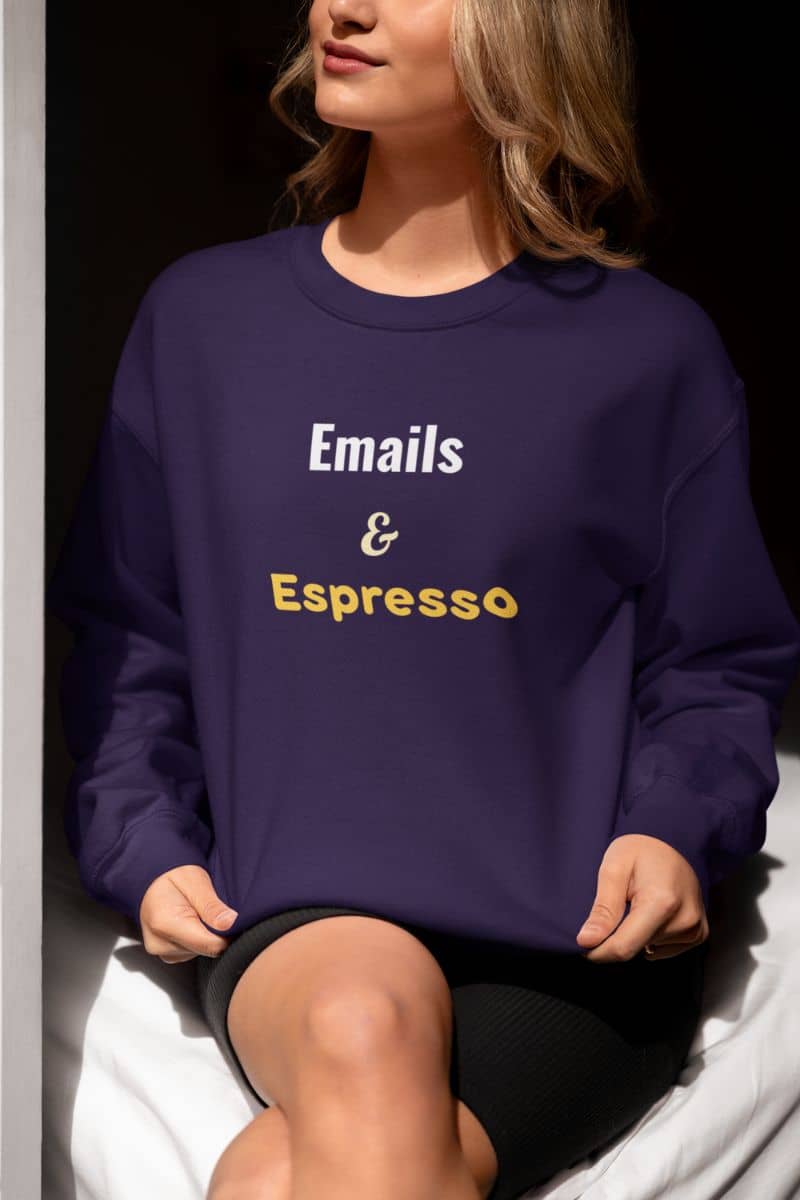 Warm casual pullover with a person wearing a purple sweatshirt with 'Emails & Espresso' text.