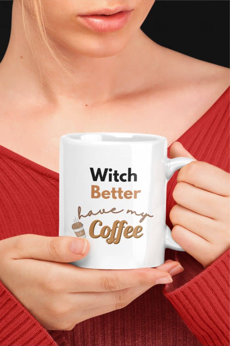 Witchy coffee mug with a person holding a white mug with text 'Witch Better have my Coffee' against a dark background