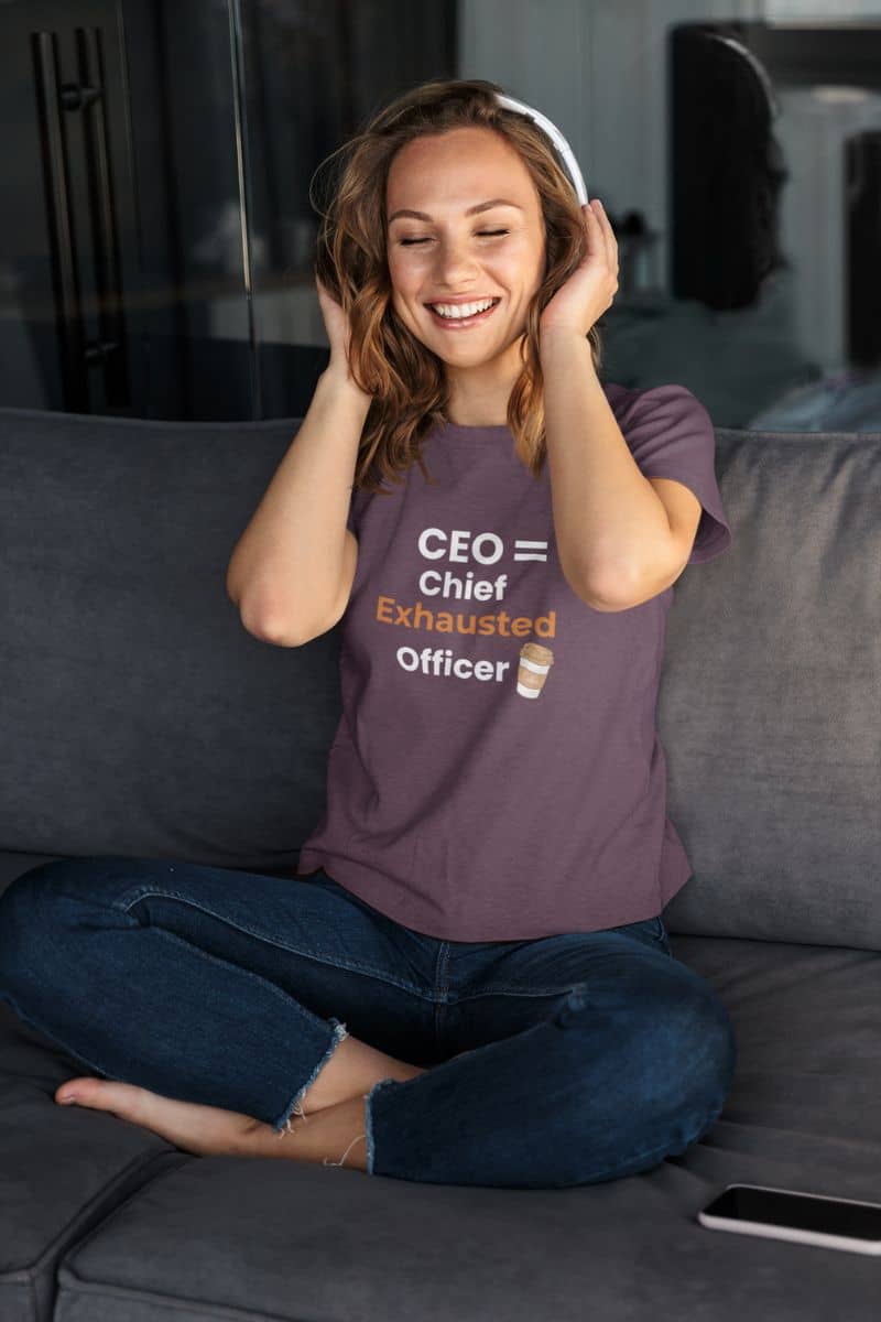 Work burnout t-shirt with a person wearing a purple t-shirt with text, sitting on a couch.
