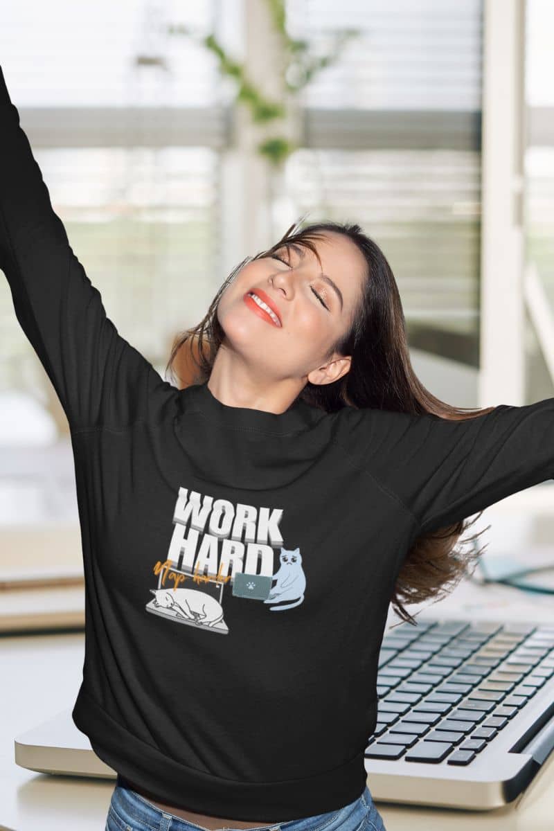 Work hard, nap harder sweatshirt with a girl stretching her arms behind her back to stretch after finishing work