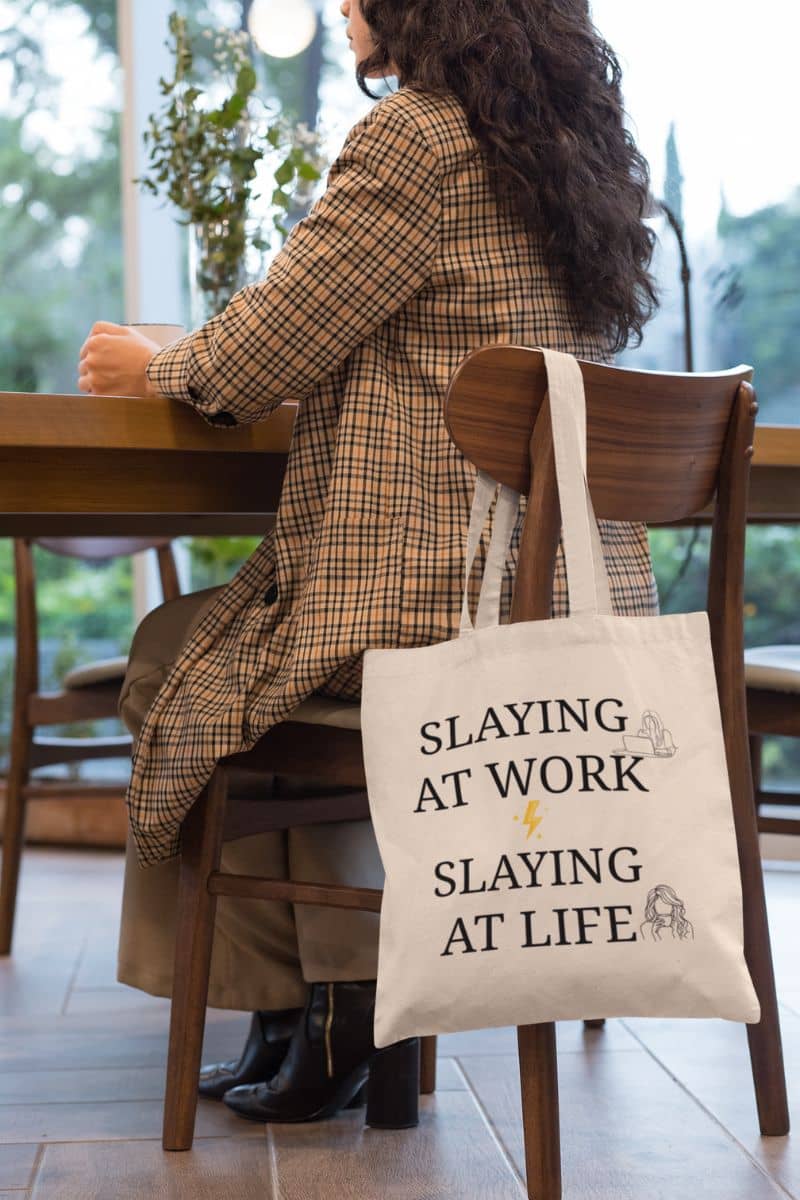 Work life balance tote bag with young girl hanging tote bag on chair while drinking coffee at coffee shop