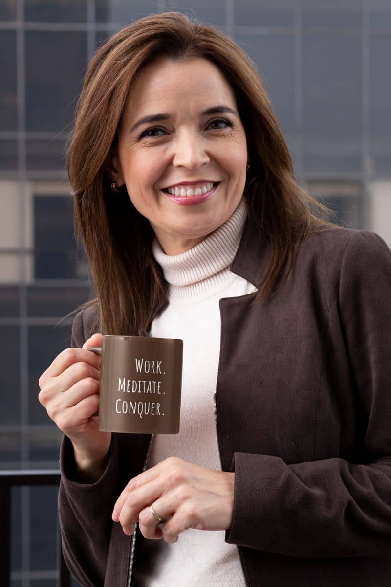 Work meditate conquer coffee mug with a middle-aged woman in a suit holding a cup of coffee