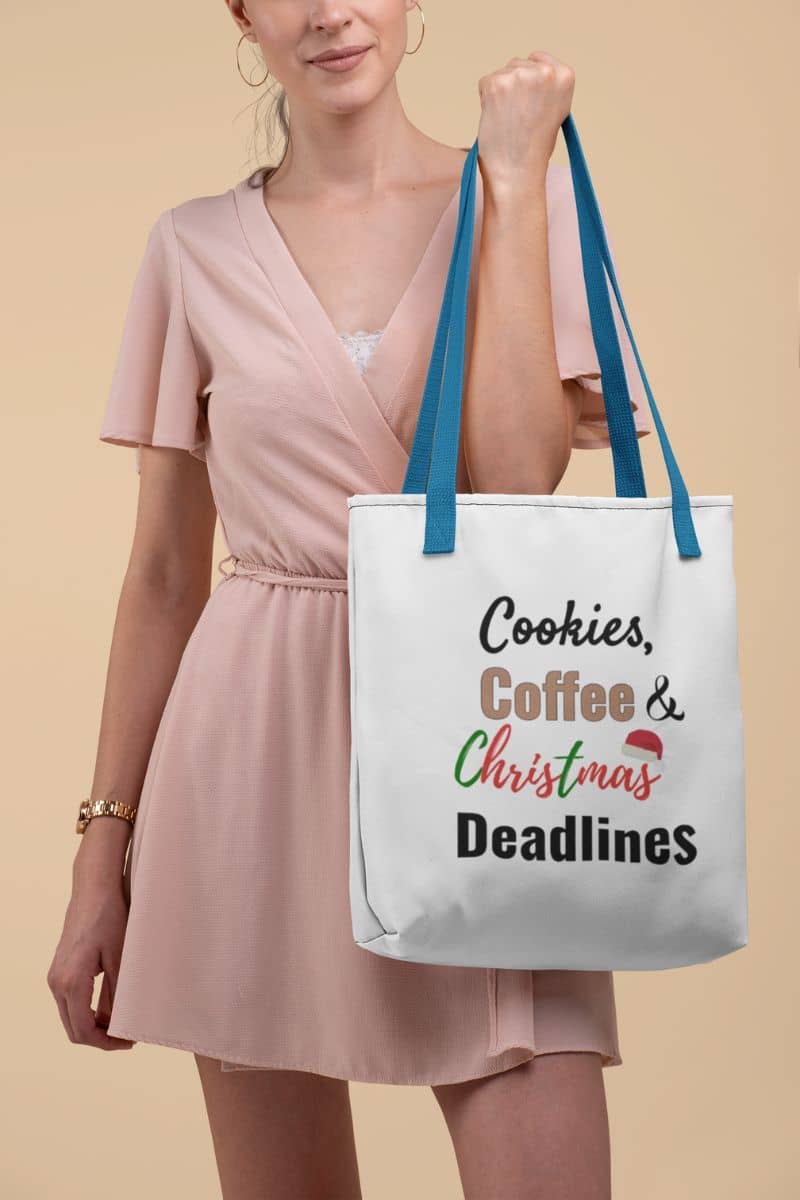 caffeine lover tote with a woman holding a tote bag with text 'Cookies, Coffee & Christmas Deadlines' against a beige background