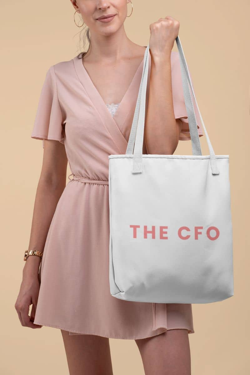canvas market tote bag with a woman holding a white tote bag with 'THE CFO' text on a beige background
