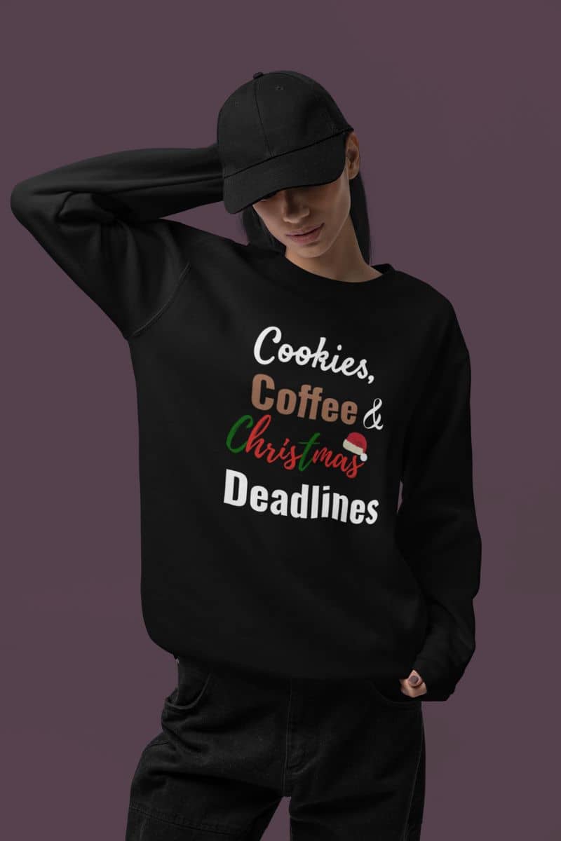 christmas stress shirt with a person wearing a black sweatshirt with 'Cookies, Coffee & Christmas Deadlines' text on a dark background