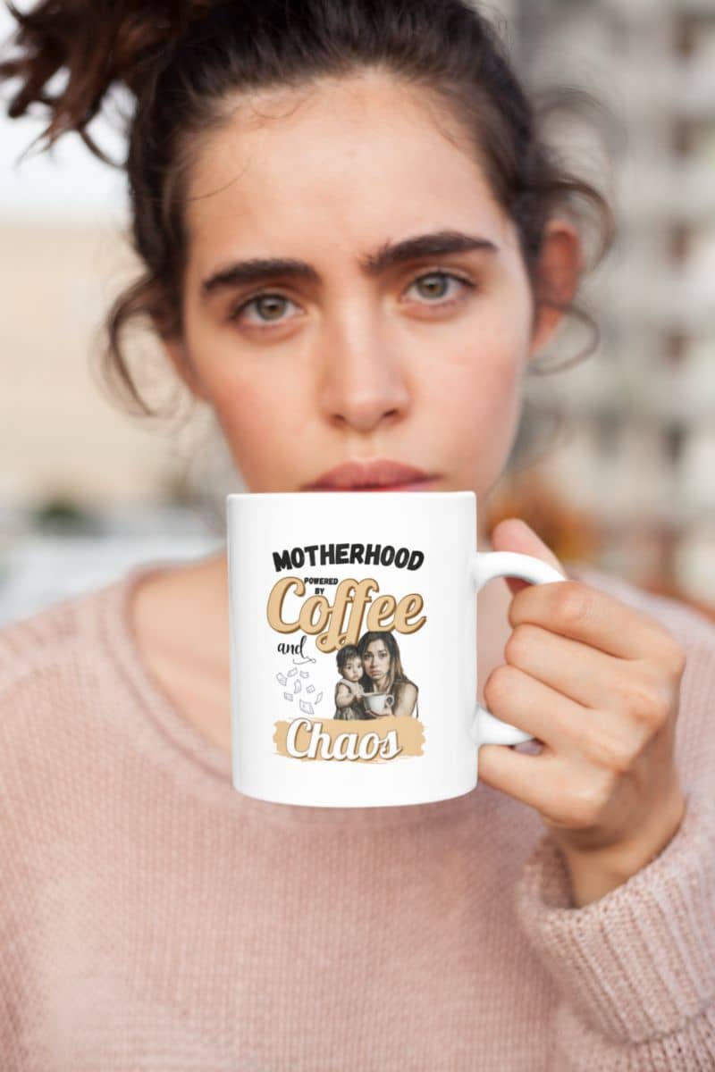 coffee fueled mom mug with a woman holding a mug with 'Motherhood Powered by Coffee and Chaos' text