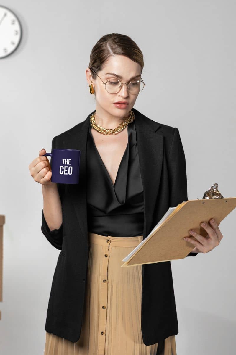 coffee mug for boyfriend with a woman holding a mug labeled 'The CEO' and a clipboard against a plain background