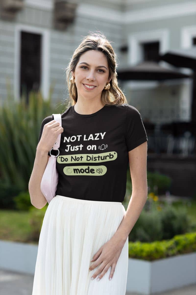 do not disturb t-shirt with a woman wearing a black t-shirt with text 'NOT LAZY, Just on 'Do Not Disturb' mode' outdoors