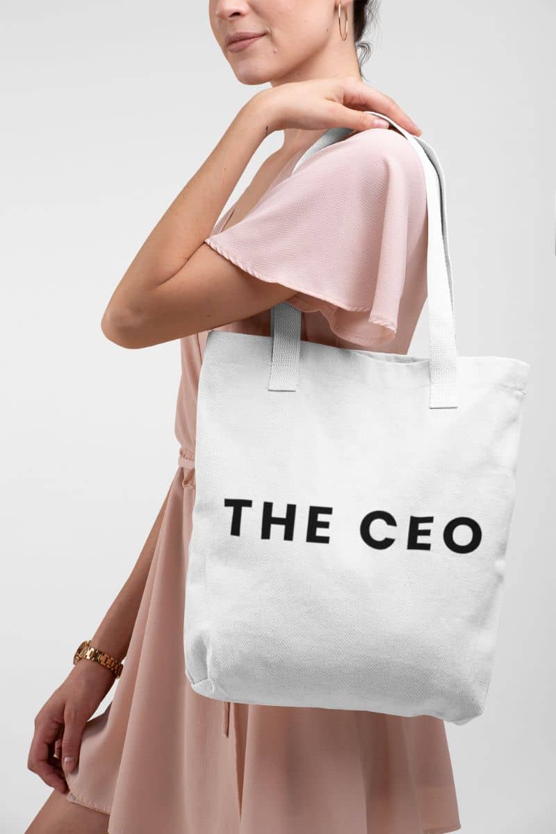 everyday carry tote with a person wearing a tote bag with 'THE CEO' text on a plain background