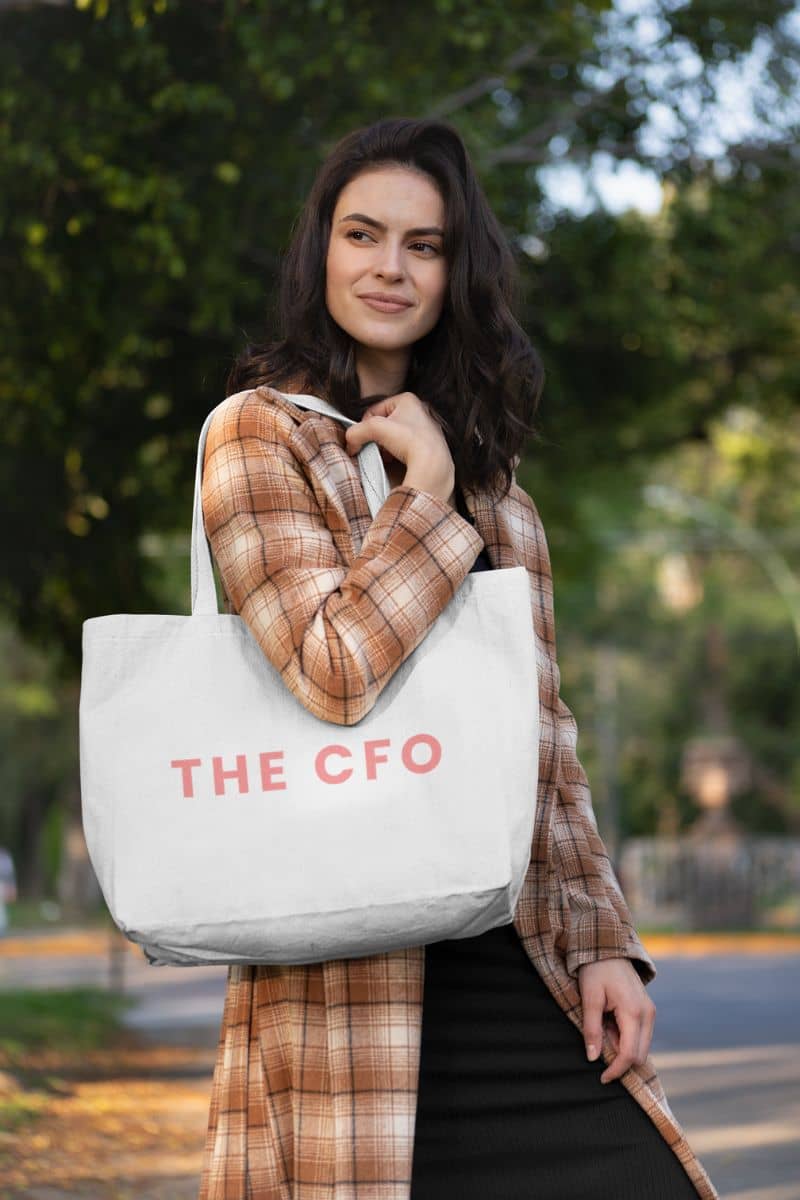 fashionable canvas tote bag with a woman holding a tote bag with 'THE CFO' text outdoors